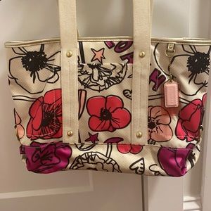 Coach multi color floral medium size handbag with zipper top